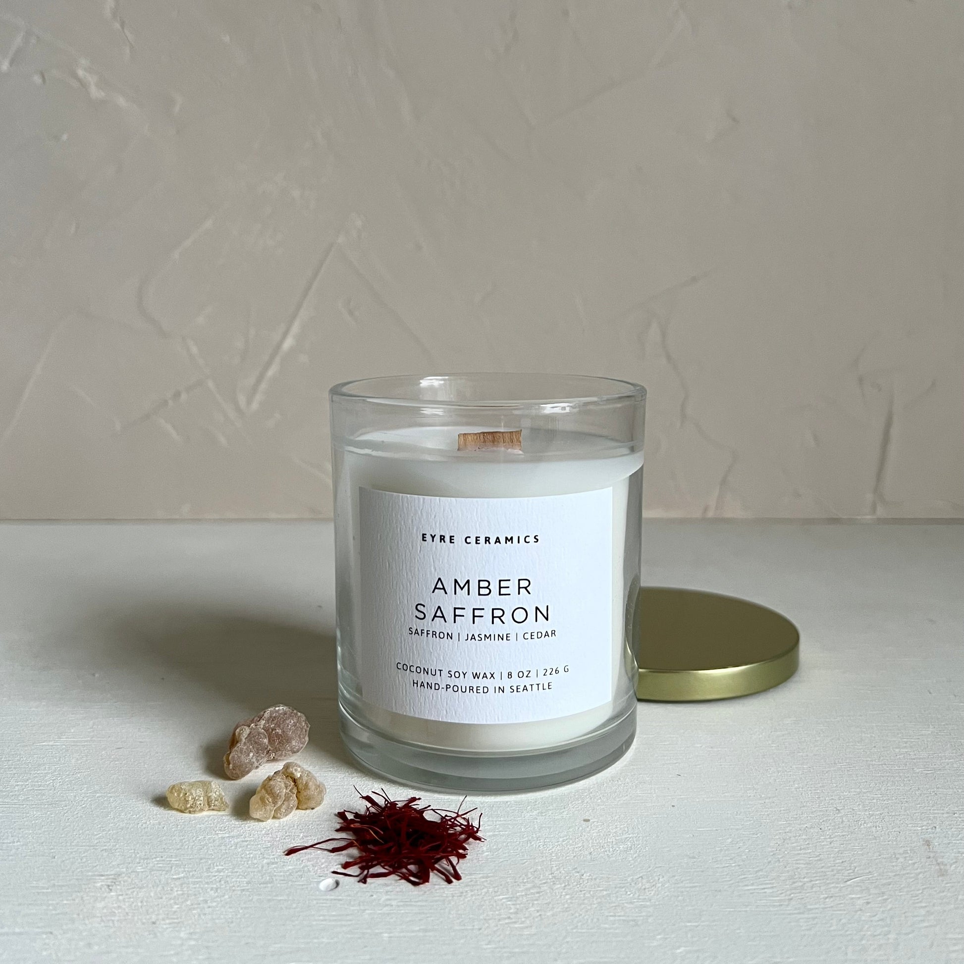 Candle labeled 'Amber Saffron' with a minimal background
