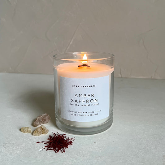 Candle labeled 'Amber Saffron' with a minimal background