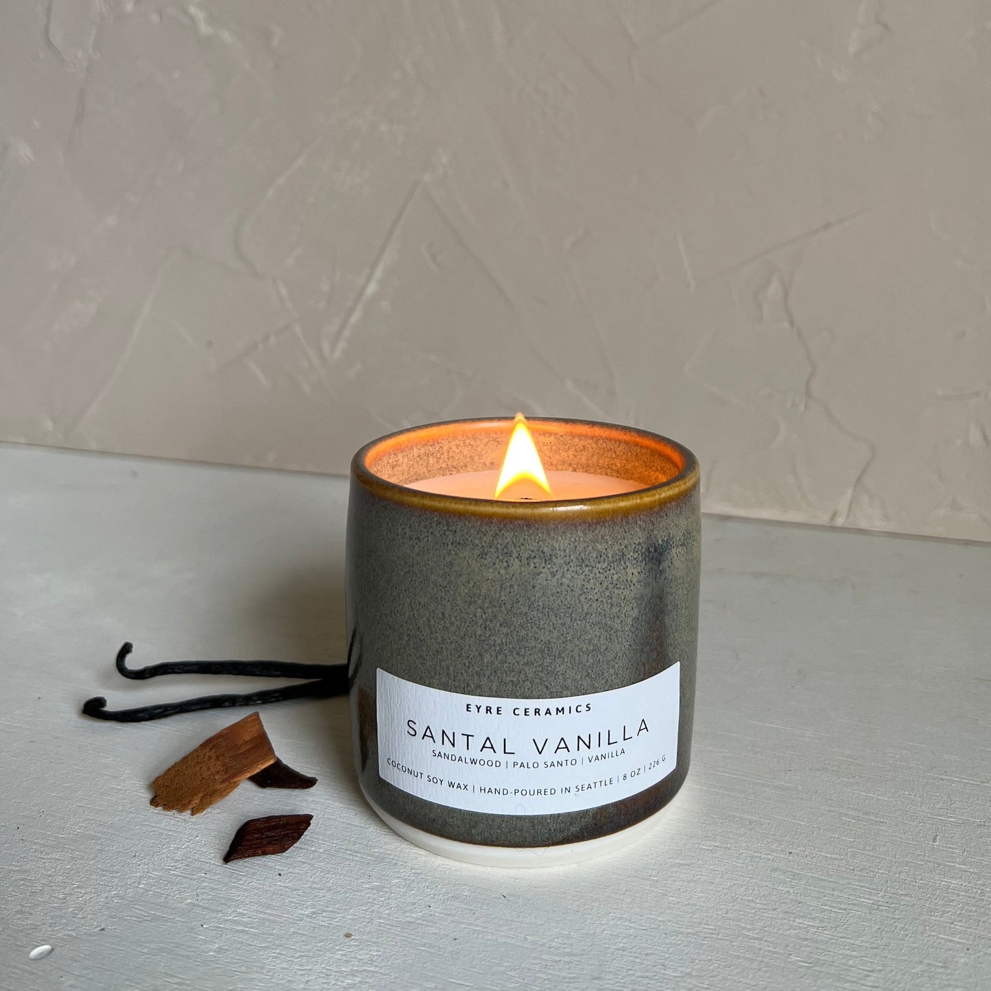 Candle with a label on a textured surface